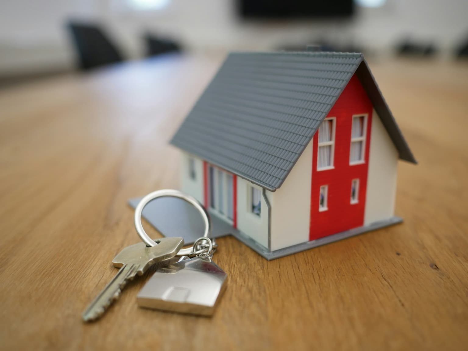 House keys and a model home on a desk