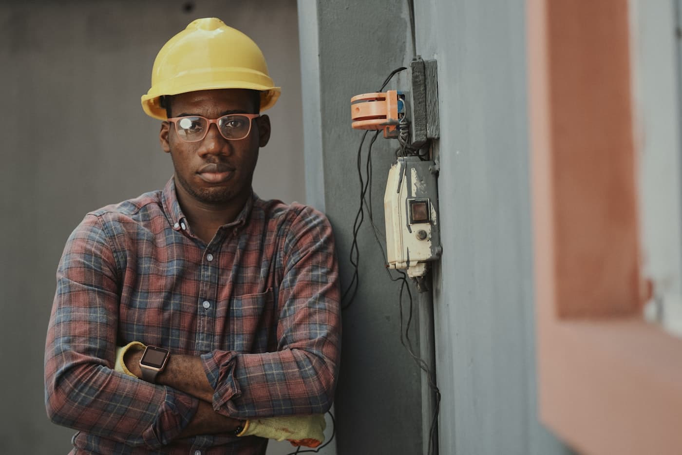 Electrician standing beside a service panel