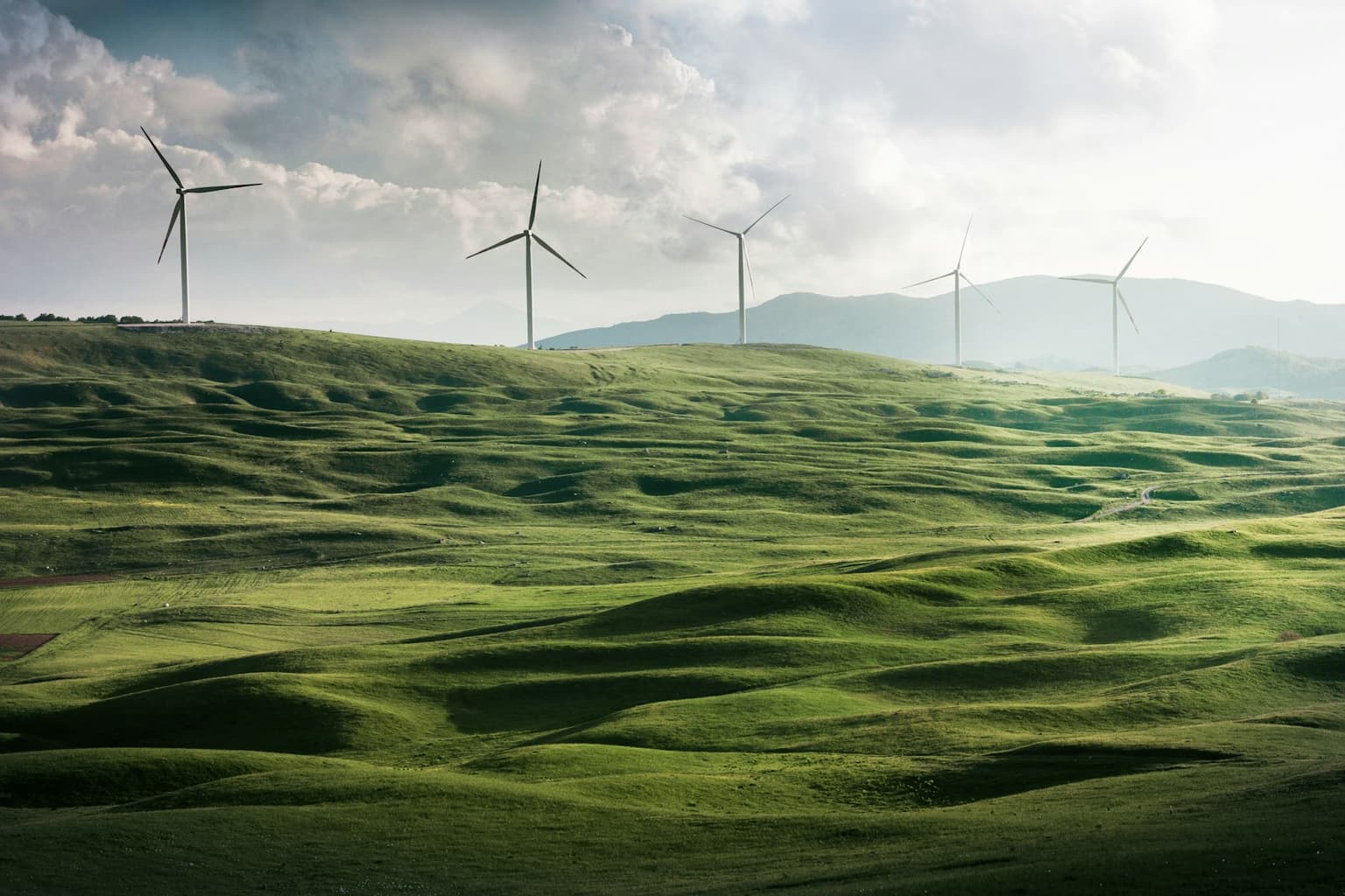 Wind turbines on rolling green hills